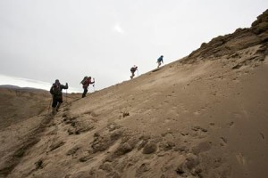 Team members trek up the slopes on Ellesmere Island to the fossil site.