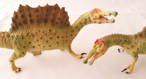 A pair of CollectA Spinosaurus dinosaur models.