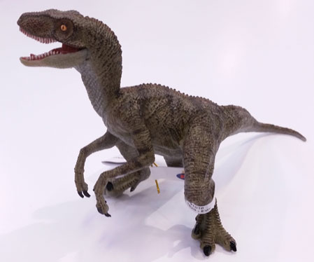 The Papo green Velociraptor dinosaur model.