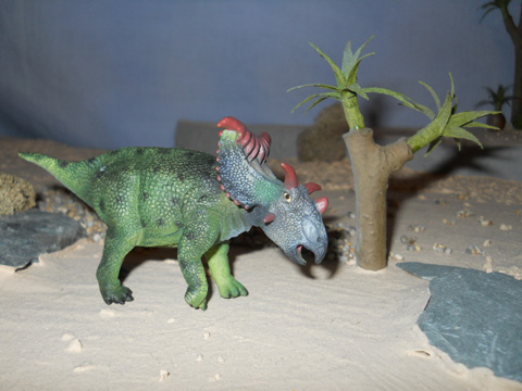 A CollectA Kosmoceratops dinosaur model.
