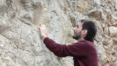Victor Fondevilla, (Autonomous University of Barcelona) examines one of the dinosaur skin fossils.