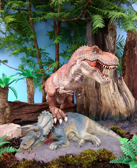 Rebor King T. rex and Fallen Queen (Triceratops) dinosaur diorama.