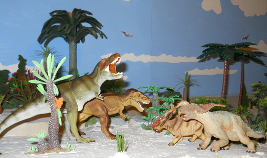 A pair of Einiosaurus dinosaurs defend themselves against a couple of T. rex.