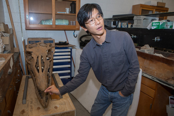 Takuya Konishi (Cincinnati University) with a Mosasaur skull cast.