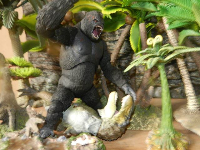 Kong model battles the Kaiyodo Sofubi Toy Box T. rex figure.