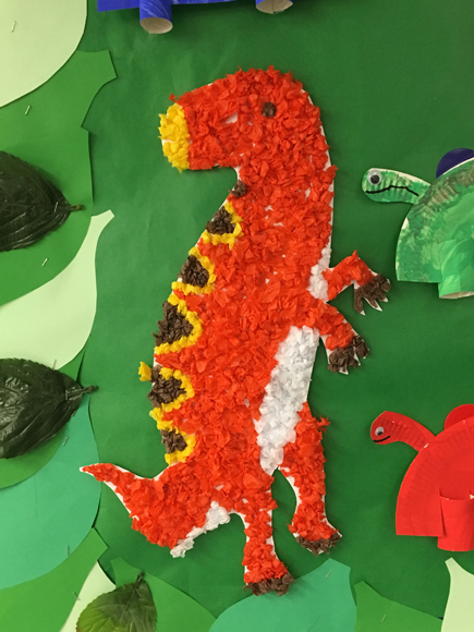 A brightly coloured dinosaur made from tissue paper.