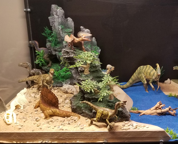 A desert scene featuring some Papo prehistoric animal models.