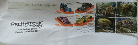 Dinosaur stamps on an envelope.