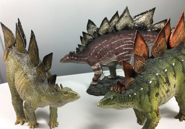 Three Rebor Stegosaurus models.