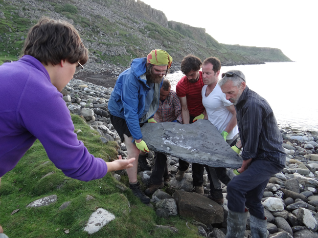 Carefully removing the pterosaur fossil from the beach.