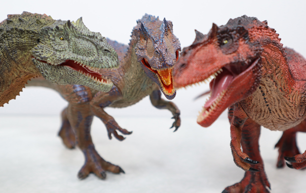 Three Rebor Saurophaganax dinosaur models.